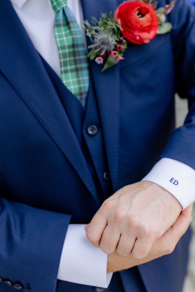 Initial detail on groom's sleeve