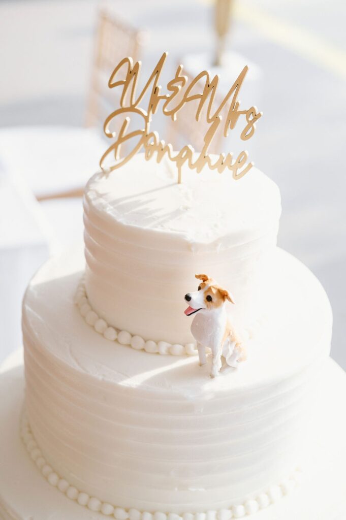 All white wedding cake with dog cake topper