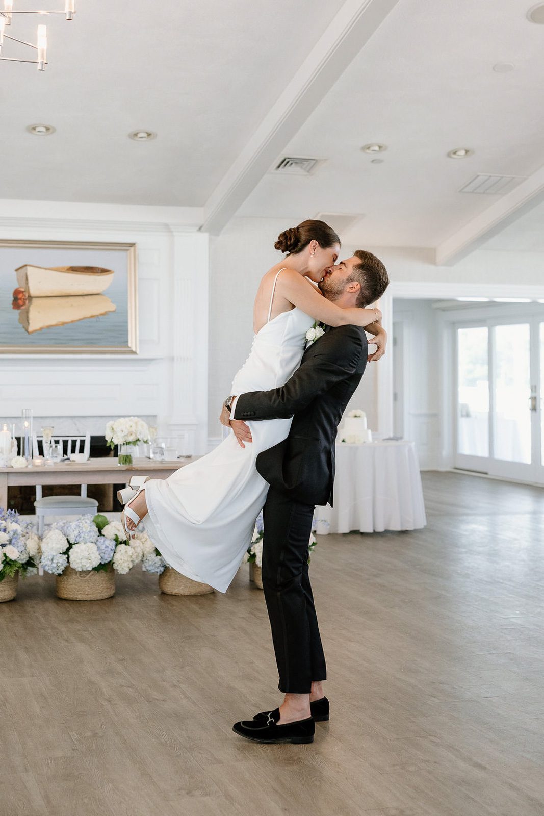 Newlyweds kissing during their first dance, planned as part of their wedding timeline.