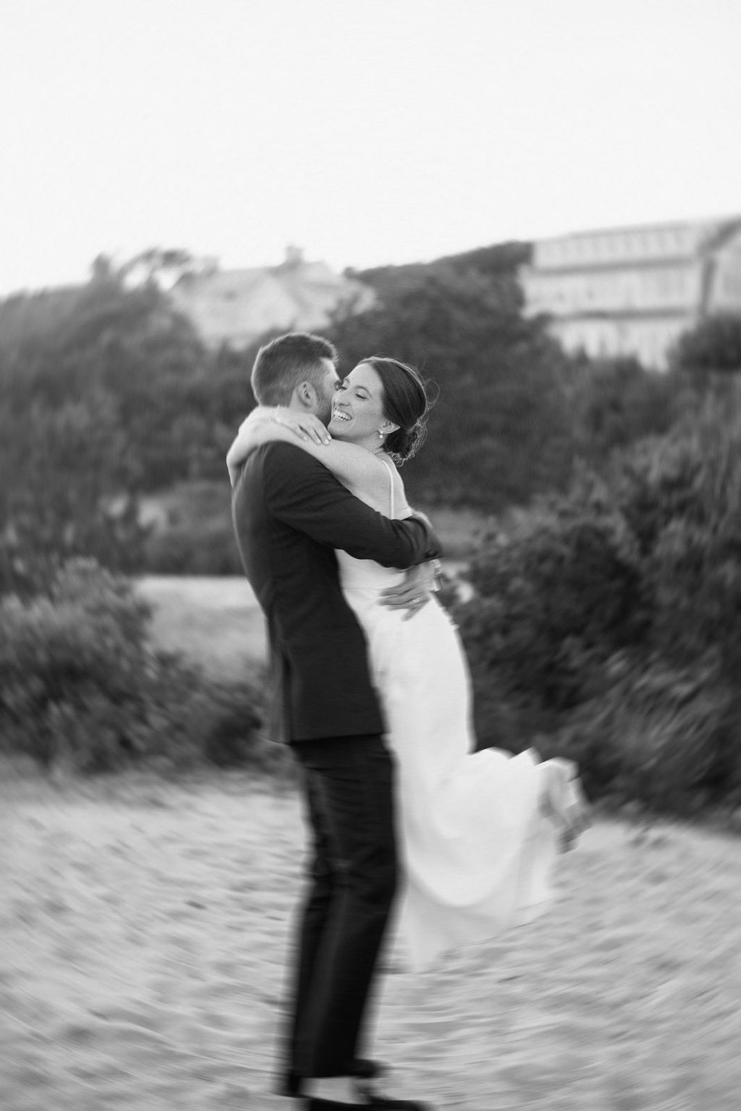 newlyweds dancing on the sand, planned as part of their wedding timeline. 