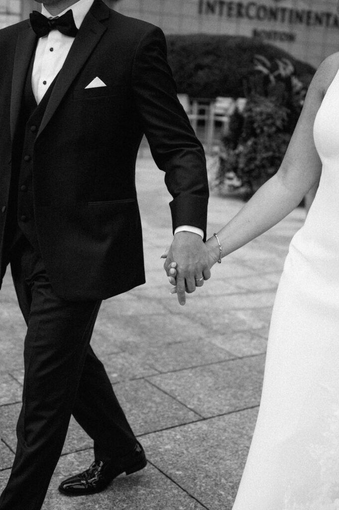 Couple holding hands walking in Boston