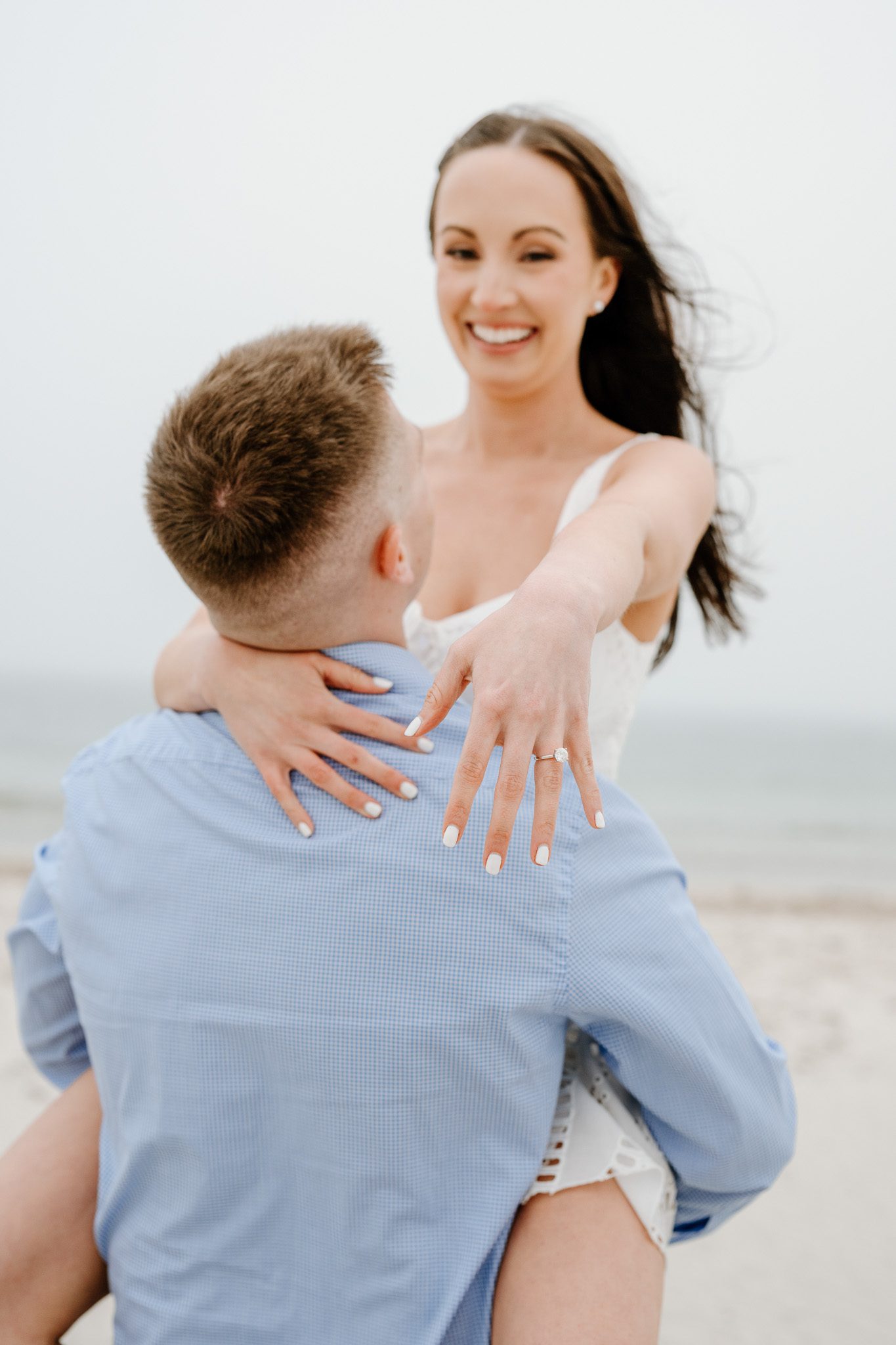 a couple showing off her engagement ring. 