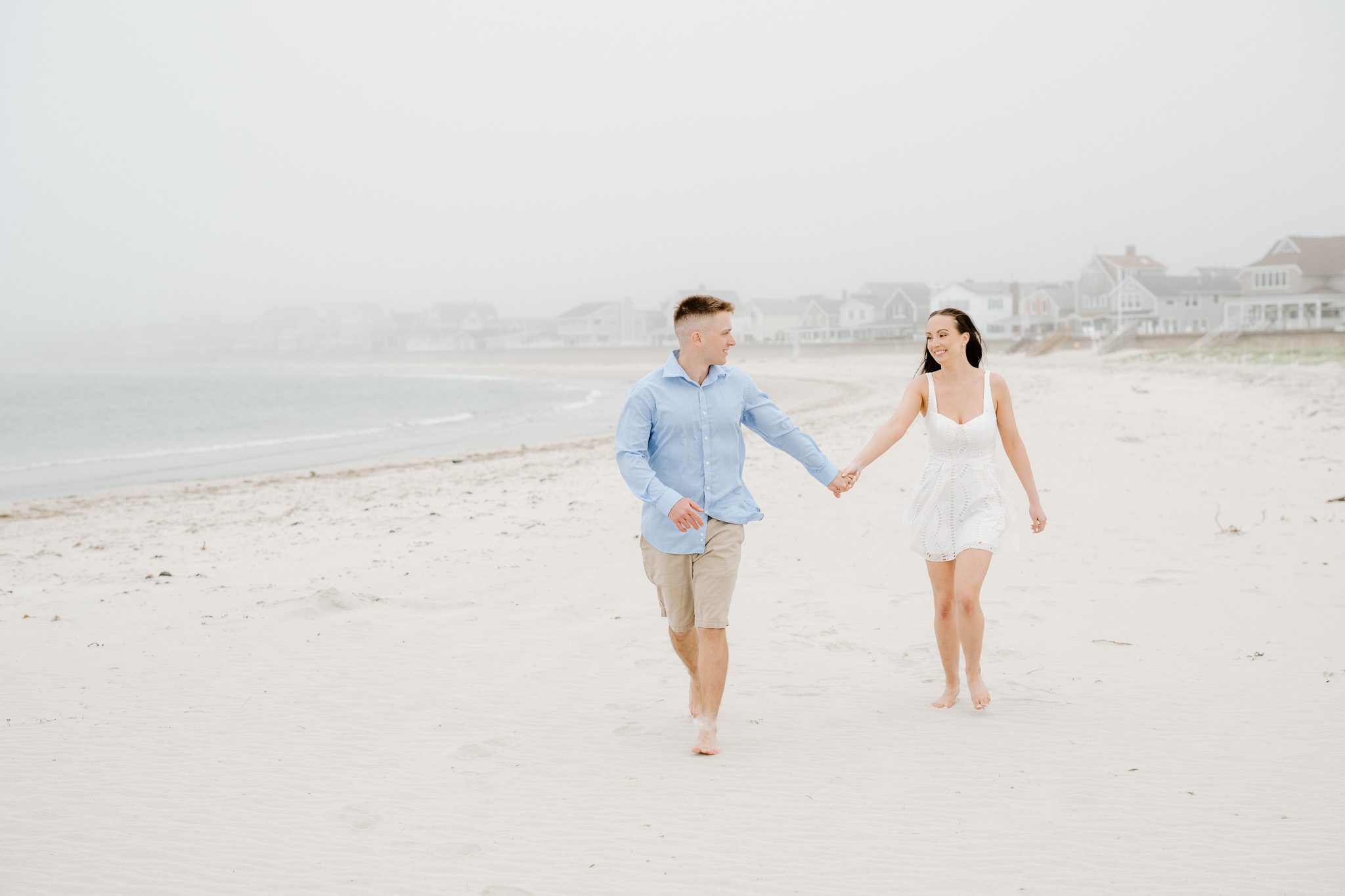 a couple running on the sand, comfortable in front of the camera. 
