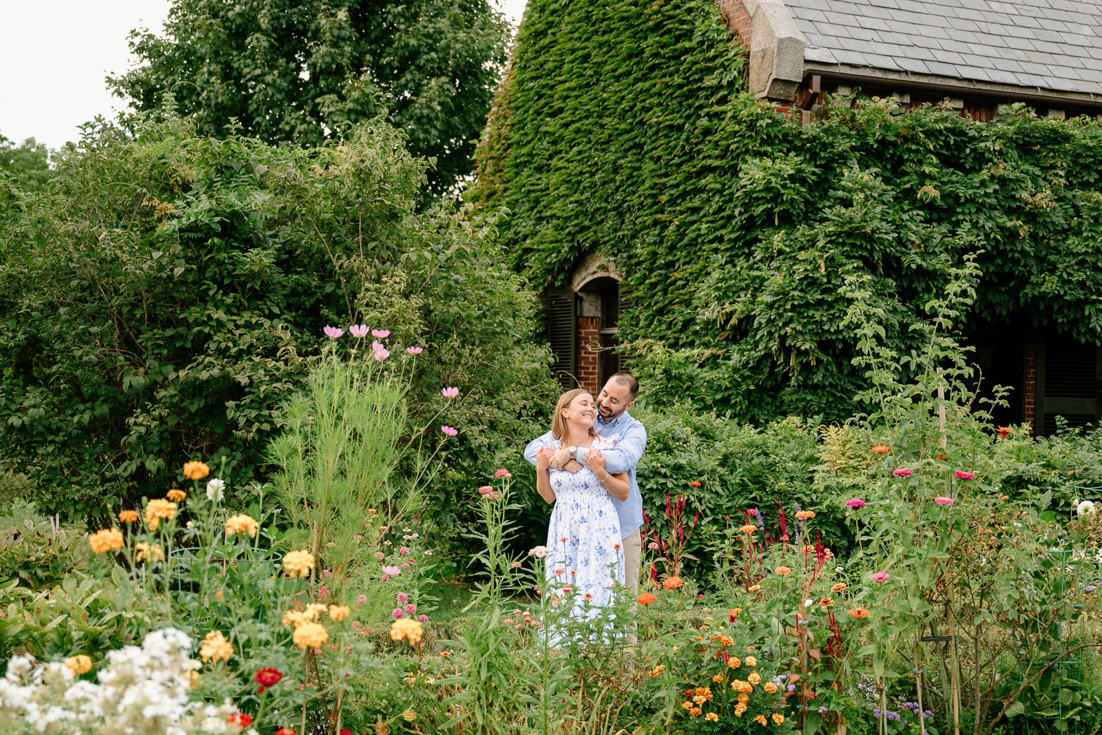couple hugging in a garden hidden in a New England estate.