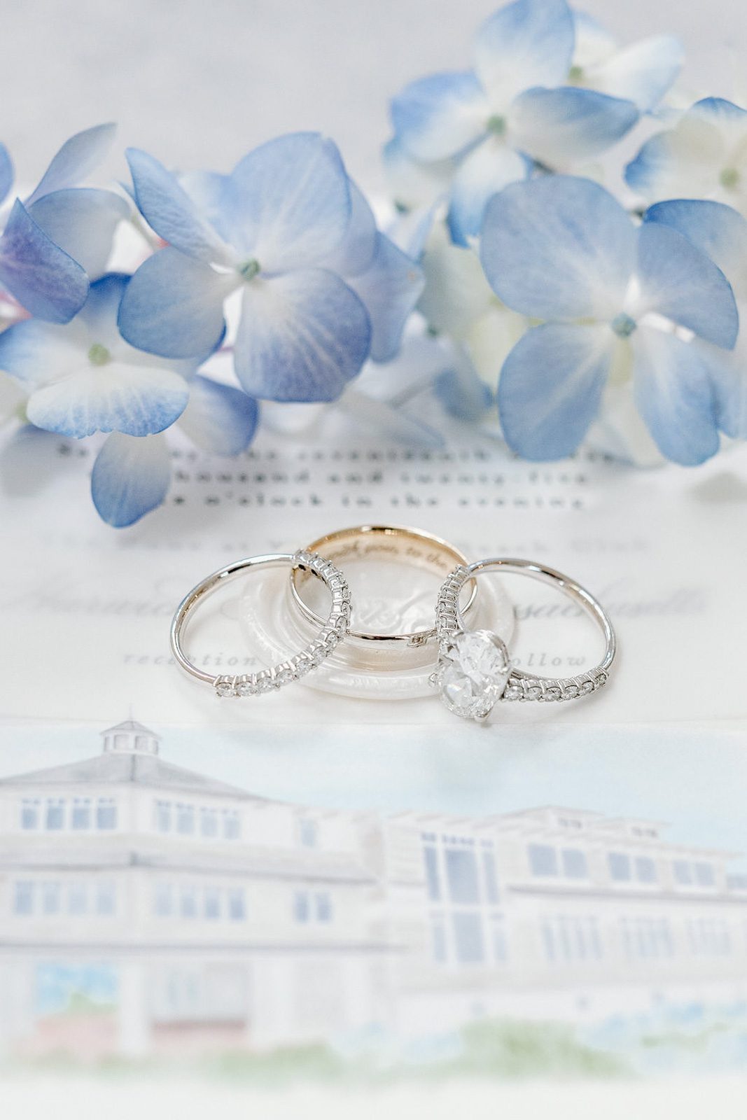wedding rings placed on top of a wedding invite. beautifully captured by their last minute wedding photographer.