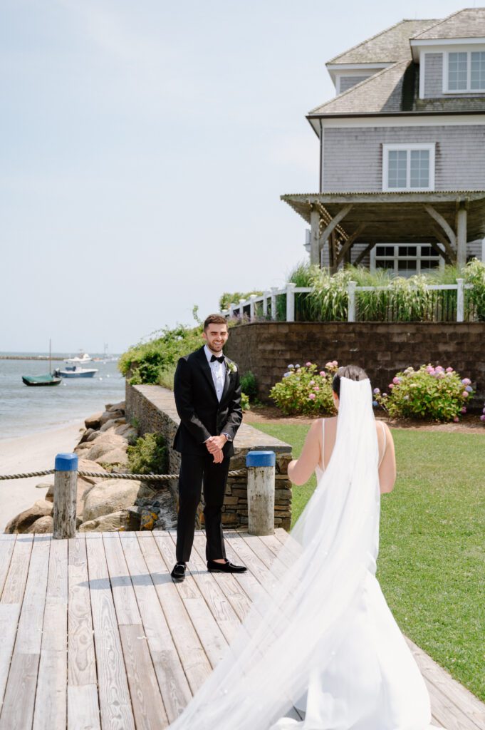 Couple sharing an emotional first look at Wychmere Beach Club on Cape Cod.