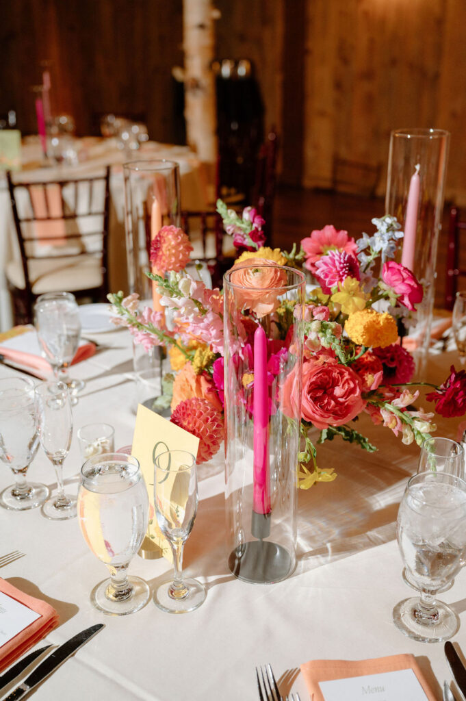Reception table details with candles and florals at vineyard wedding